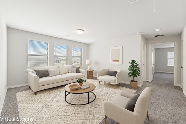 Living area with healthy amount of natural light, baseboards, and carpet flooring | Image 9