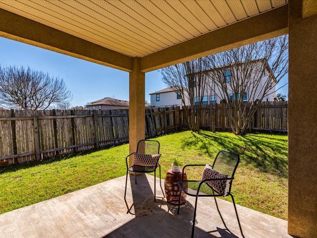 Your living space extends outdoors onto this lovely covered back porch proving ample space for configuring your ideal outdoor living area. | Image 25