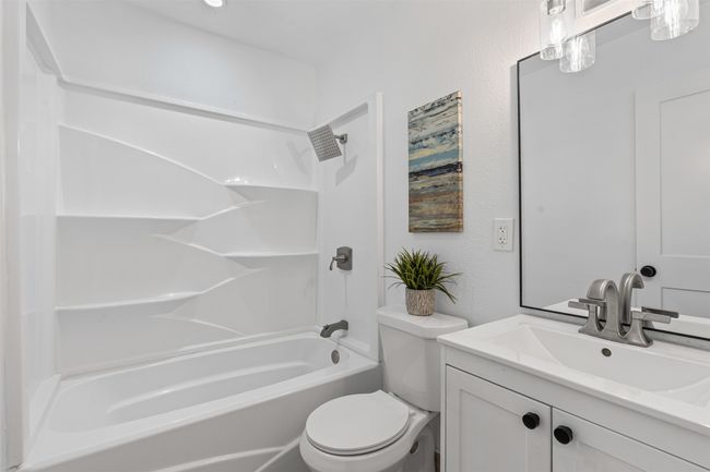 Full bath with vanity, tub / shower combination, and a textured wall | Image 24