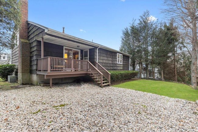 Rear view of house featuring a chimney, a yard, and central air condition unit | Image 27
