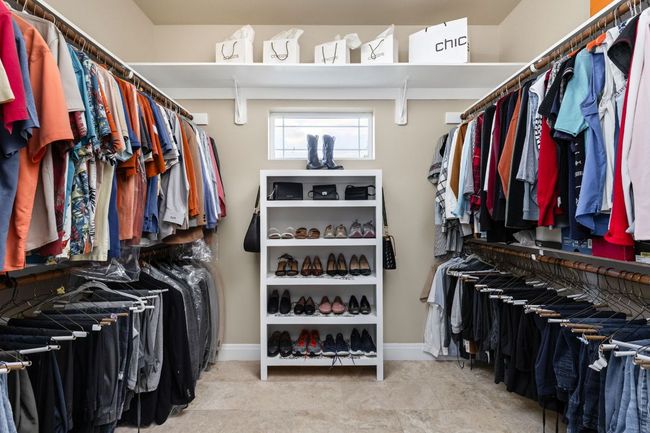 A generous walk-in closet provides ample storage space for wardrobe and accessories. | Image 20