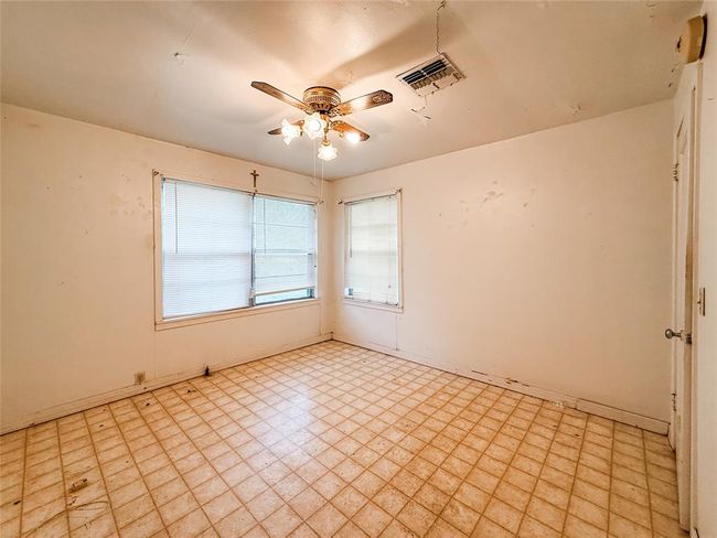 Cozy second bedroom with ample natural light, perfect for a guest room or home office. | Image 13