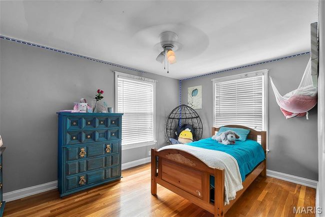 Bedroom featuring baseboards, a ceiling fan, and wood finished floors | Image 15