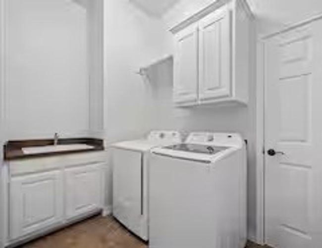 Laundry area featuring cabinet space and separate washer and dryer | Image 18