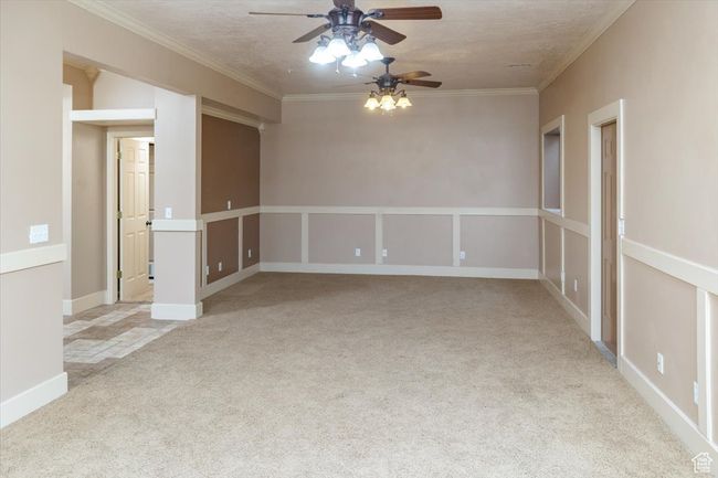 Unfurnished room with a textured ceiling, light carpet, and ceiling fan | Image 33