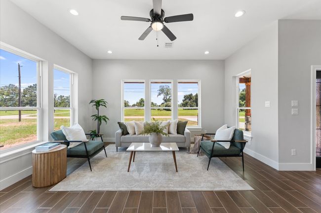 Airy open living room with large windows. | Image 9