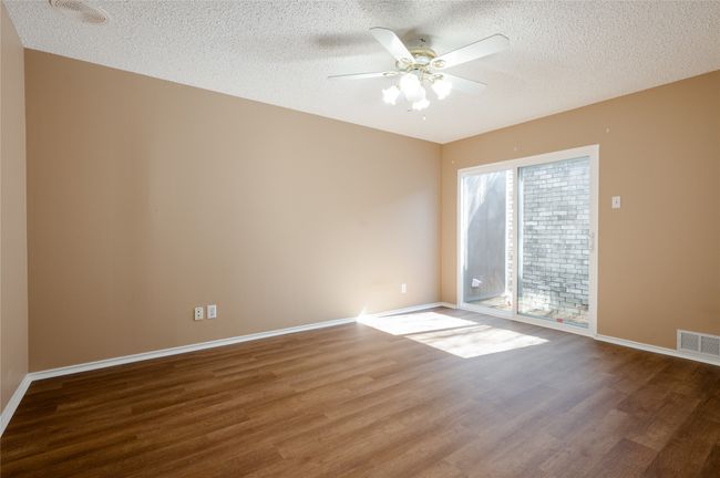 Spare room with baseboards, ceiling fan, visible vents, and wood finished floors | Image 24