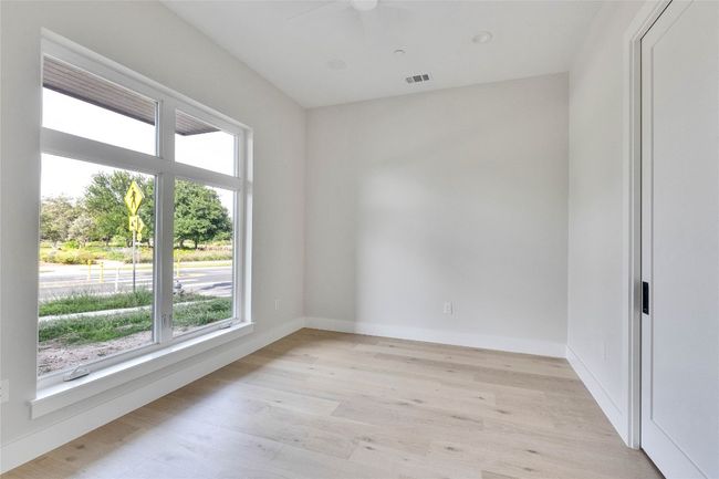 Unfurnished room featuring healthy amount of natural light, a ceiling fan, light wood-type flooring, and baseboards | Image 17