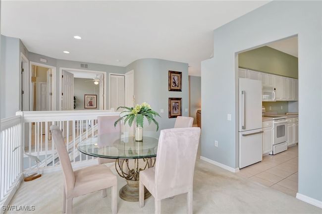 Dining area nicely furnished, featuring light colored carpet, and recessed lighting | Image 7