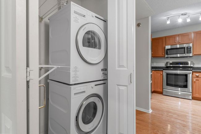 In-unit laundry closet with a new washer and dryer, installed in 2022. | Image 14