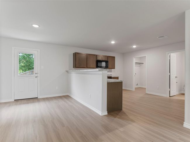 Bright dining area seamlessly connected to an open kitchen. | Image 5