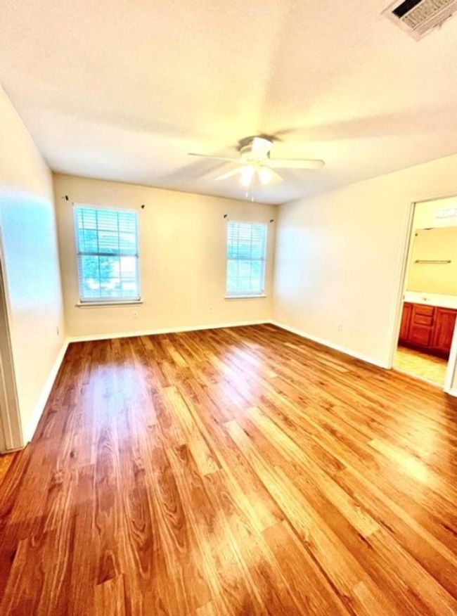 Spare room with plenty of natural light, light wood-type flooring, ceiling fan, and baseboards | Image 11