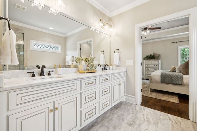 Marble/granite countertops, double sinks, and beveled mirror border make this space light and bright for clean and neutral pallet... | Image 28