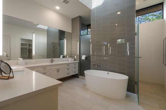 Full bath featuring vanity, tile walls, a soaking tub, walk in shower, and tile patterned flooring | Image 18