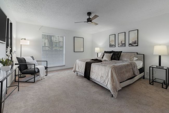 Bedroom featuring ceiling fan, a textured ceiling, and carpet | Image 25