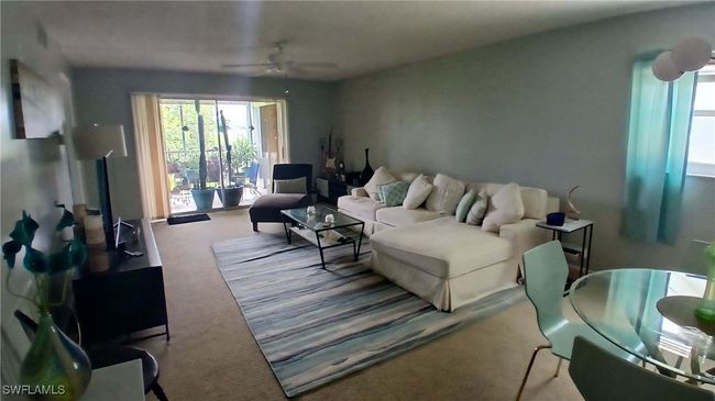 Carpeted living room with ceiling fan | Image 5