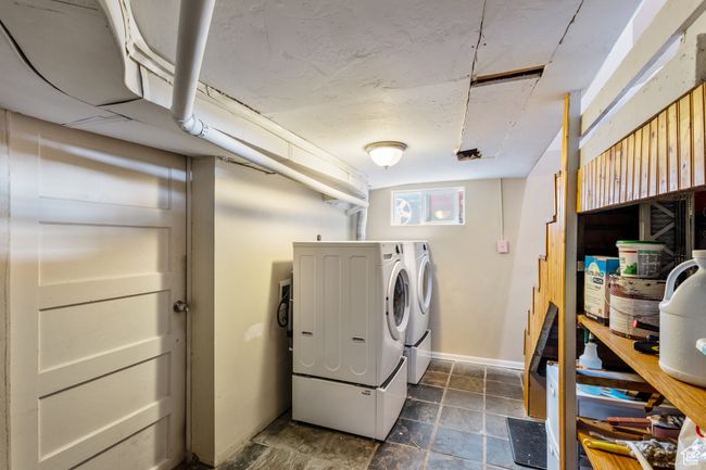 Clothes washing area with separate washer and dryer, baseboards, stone finish floor, and laundry area | Image 16