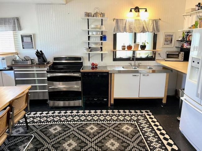 The kitchen is huge and a great gathering space. This is just half of the kitchen. There is a built in bench for seating. | Image 13