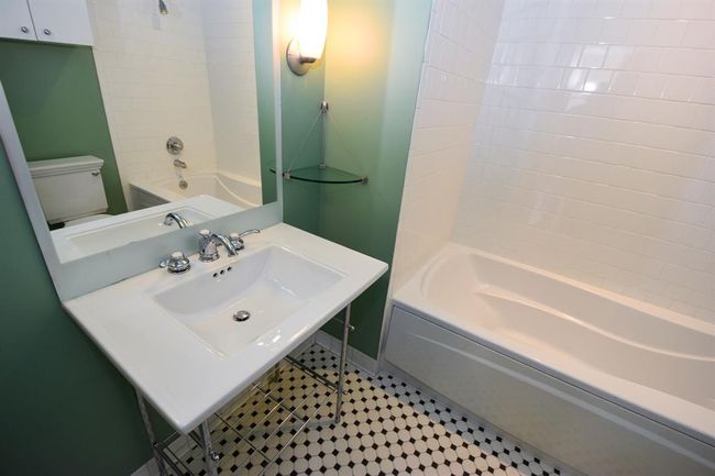 The second bathroom features a stylish sink and a luxurious soaking tub, offering a relaxing retreat. | Image 33