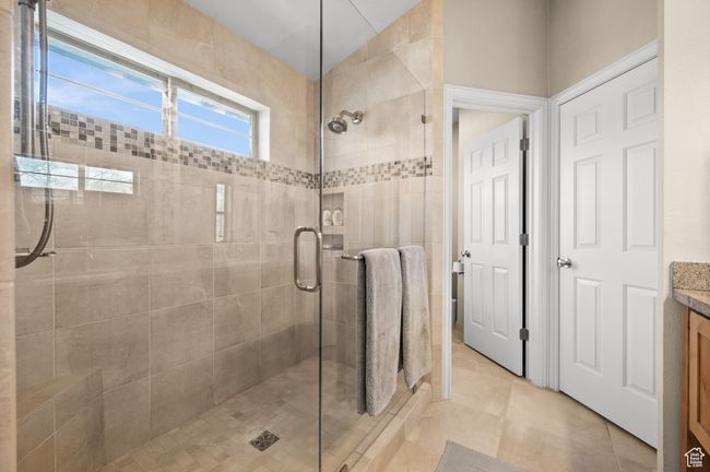 Bathroom with vanity, tile patterned flooring, and a stall shower | Image 22