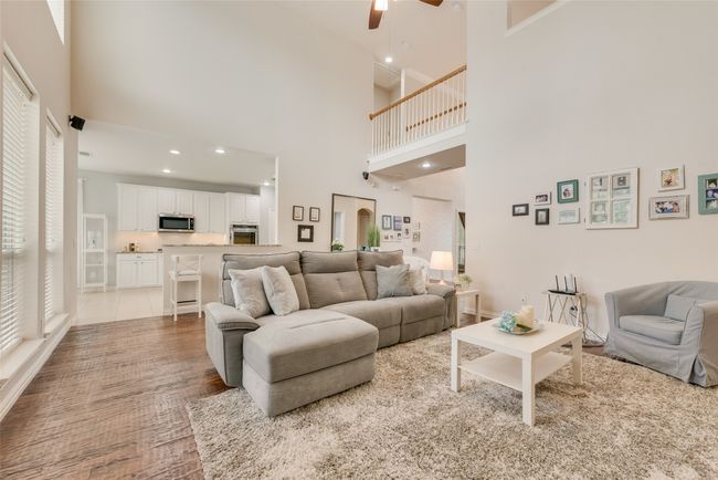 Living room featuring ceiling fan, a high ceiling, and recessed lighting | Image 12