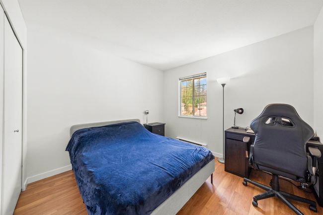 Bedroom featuring baseboards, a baseboard heating unit, and wood finished floors | Image 24