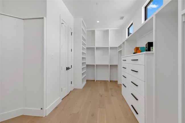 Walk in closet featuring light wood-style flooring | Image 25