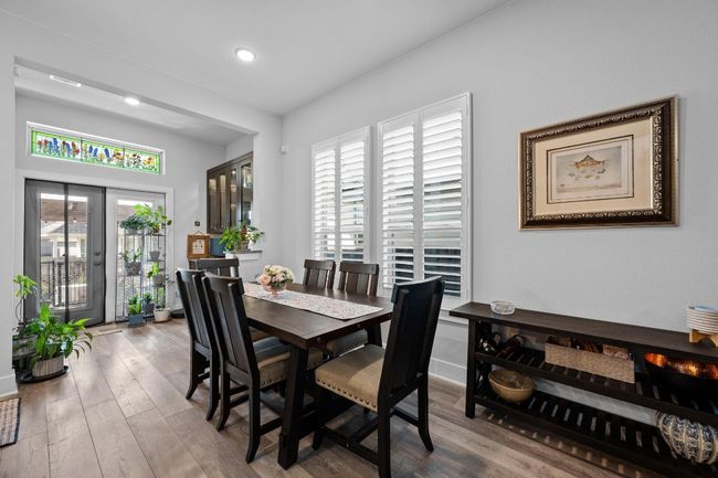 The upper cabinets over the desk area have glass fronts with interior lighting | Image 12