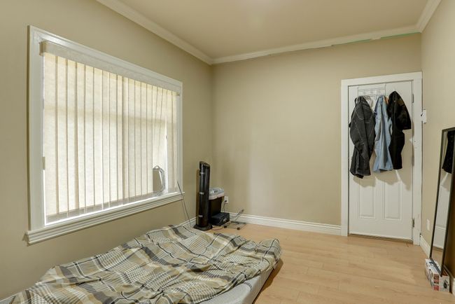 Bedroom with wood finished floors, crown molding, baseboards, and multiple windows | Image 34