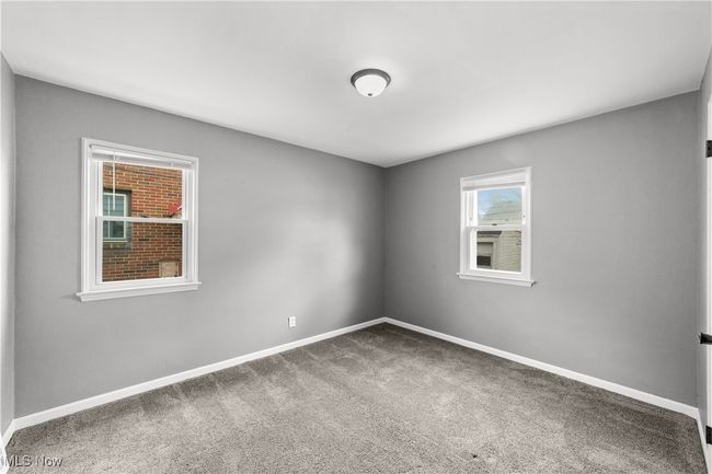 Carpeted bedroom with baseboards | Image 18