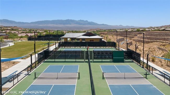 View of tennis court featuring community basketball court, a mountain view, and fence | Image 72