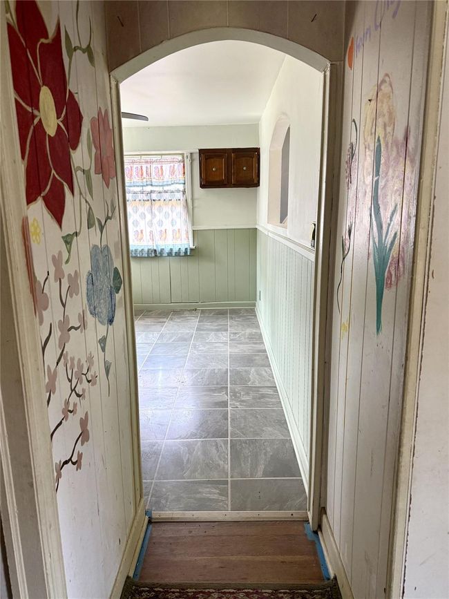 Hallway with wainscoting and arched walkways | Image 15