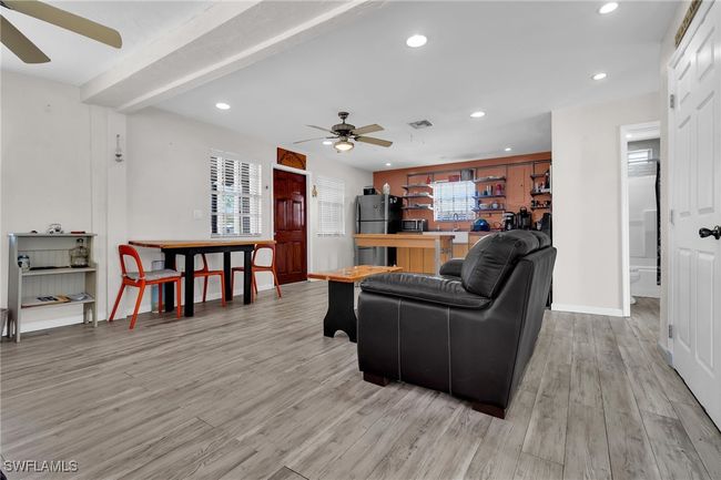 Living area with ceiling fan, light flooring, and recessed lighting | Image 10