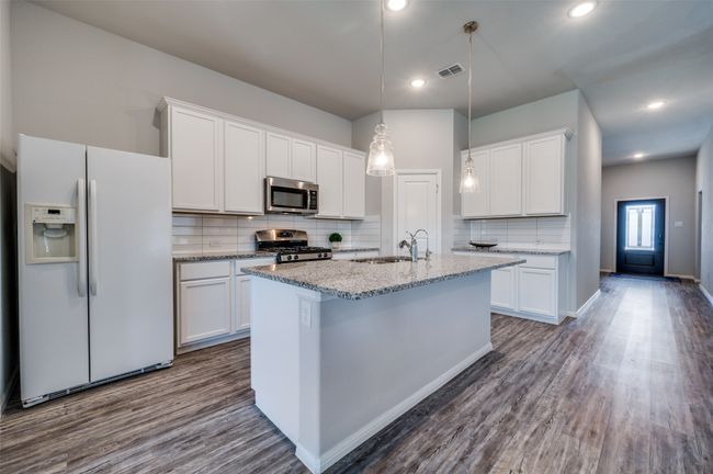 Granite Kitchen Island w/ sink for meal prep and family gathering space | Image 8