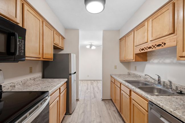 Kitchen includes Newer Stainless Range, Dishwasher, New Refrigerator, New Counter Tops, Fresh Paint & new LVP Flooring | Image 10