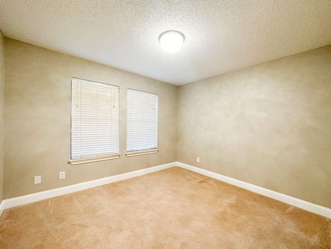 Empty room with carpet, baseboards, and a textured ceiling | Image 9