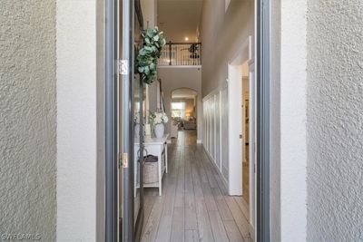 Hall featuring a towering ceiling and hardwood / wood-style flooring | Image 3