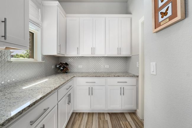 Butler Pantry with loads of cabinets and a pantry closet | Image 9