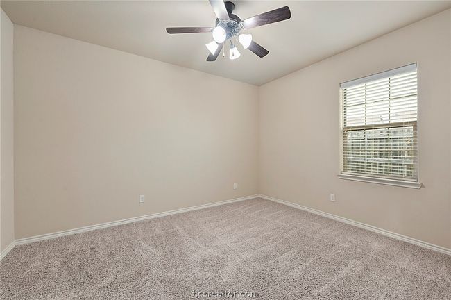 Carpeted spare room featuring baseboards and ceiling fan | Image 6