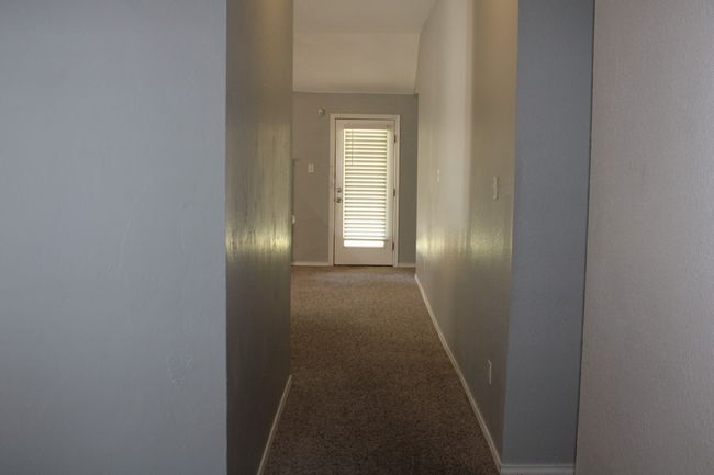 Hall with baseboards and carpet | Image 8
