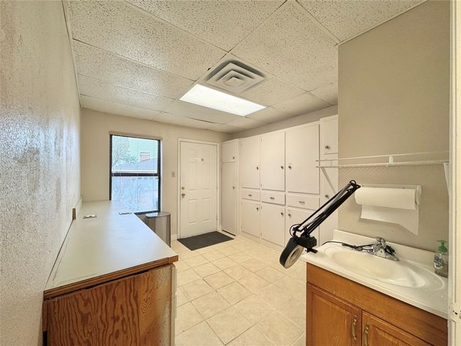 Bathroom featuring sink, a paneled ceiling, and tile patterned floors | Image 35