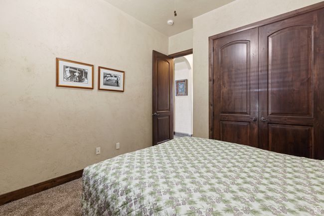 Carpeted bedroom with arched walkways and baseboards | Image 16