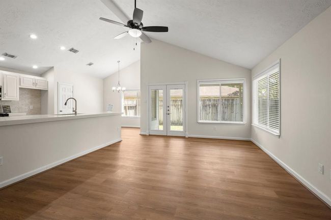 A bright and open living space with modern vinyl plank flooring | Image 9