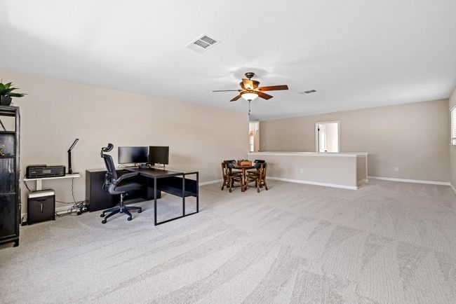 The oversized upstairs loft serves as a flexible game room, media lounge, or secondary living area. | Image 25