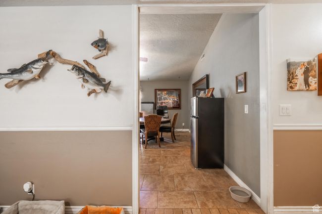 Hall with a textured ceiling and baseboards | Image 19