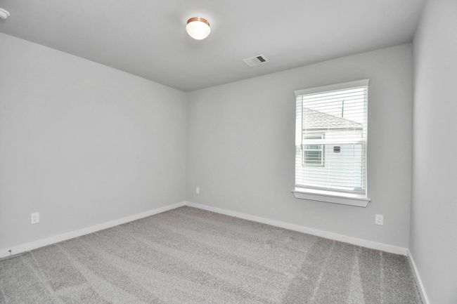 Secondary bedroom features plush carpeting, large windows that let in plenty of natural light, bright paint, and spacious closets. | Image 33