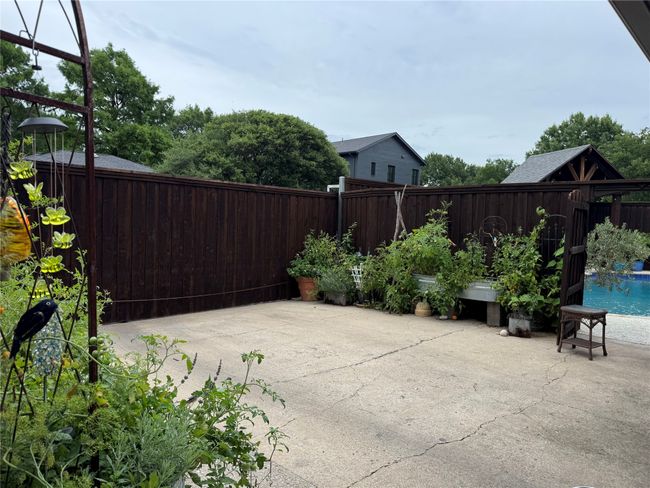 Fenced backyard with a patio | Image 31