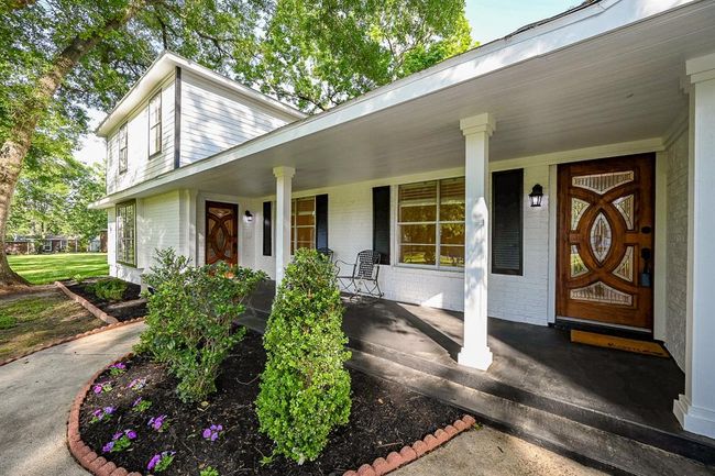 Sit and relax on the large front porch. Beautiful doors welcome family and friends. | Image 4