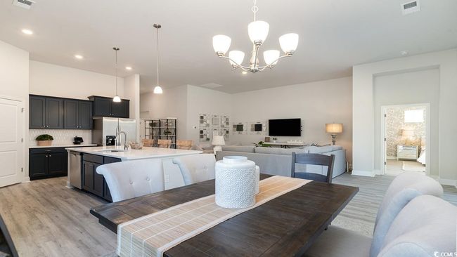 Dining area with a notable chandelier and light wood-type flooring | Image 20