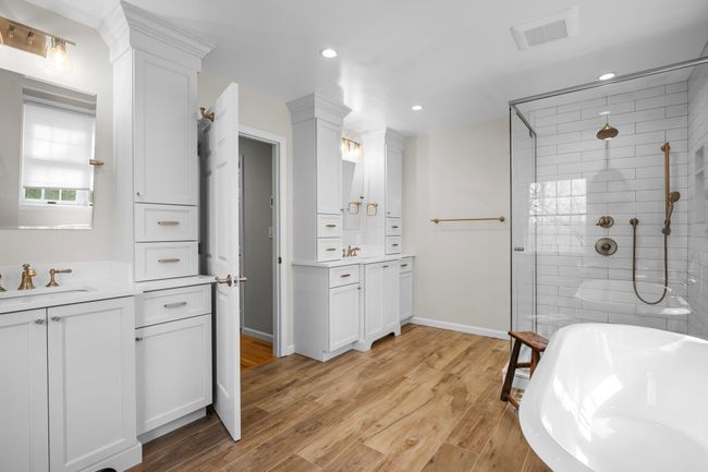 Dual vanities with ample storage and sophisticated lighting elevate this luxurious bathroom, with radiant heated floors, designed for both function and style. | Image 25